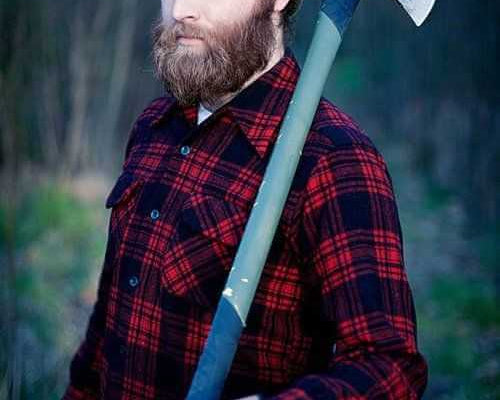 Man with full beard wearing a plaid shirt and beanie holding an axe outdoors Halloween beard costume