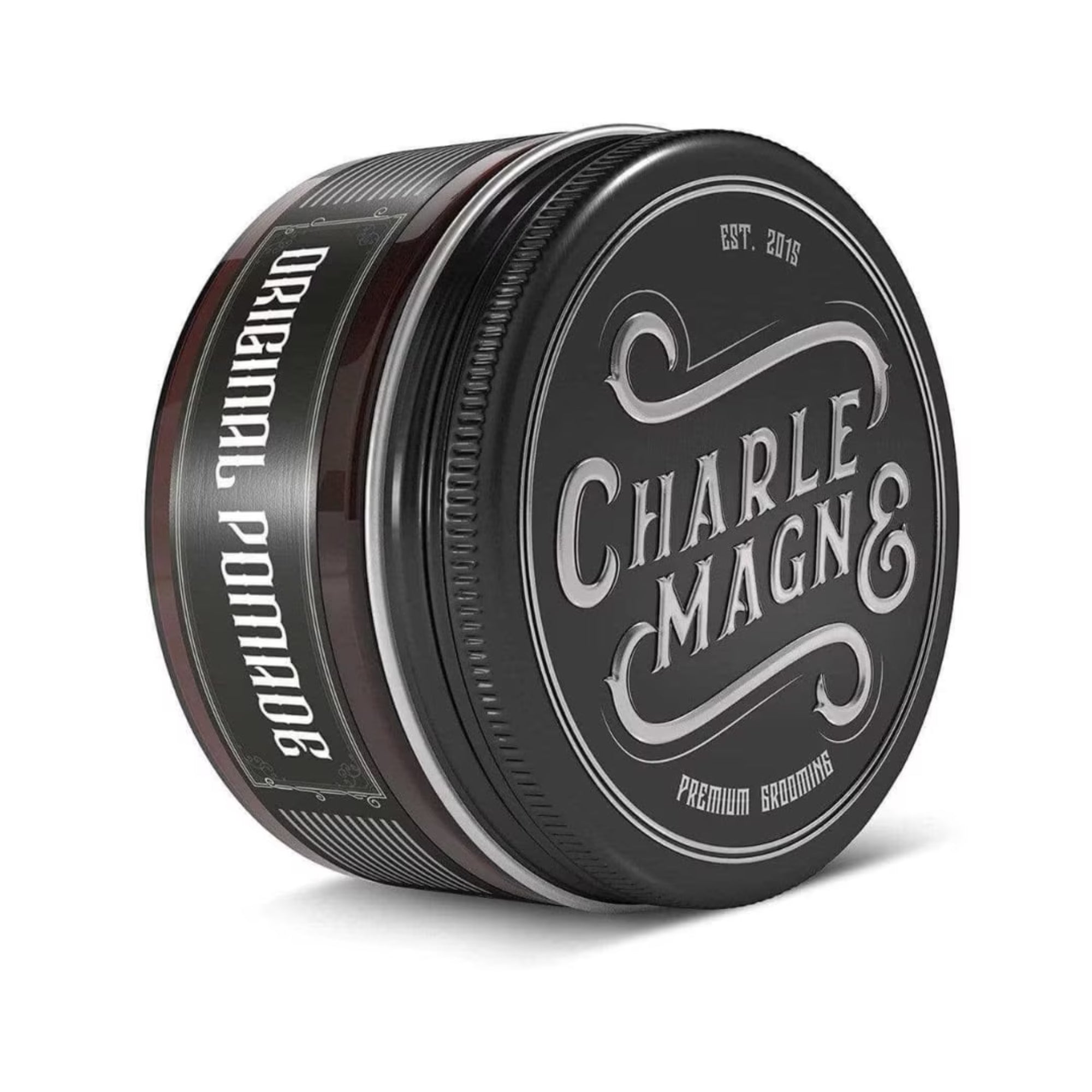 A black metal tin of Charle Magn& Original Pomade, showing the front label and side label, on a white background.
