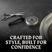 Hair pomade matte finish with linen scent next to grooming tools on black surface