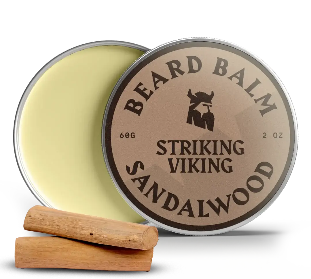 Sandalwood beard balm tin with lid open, two wood pieces beside.
