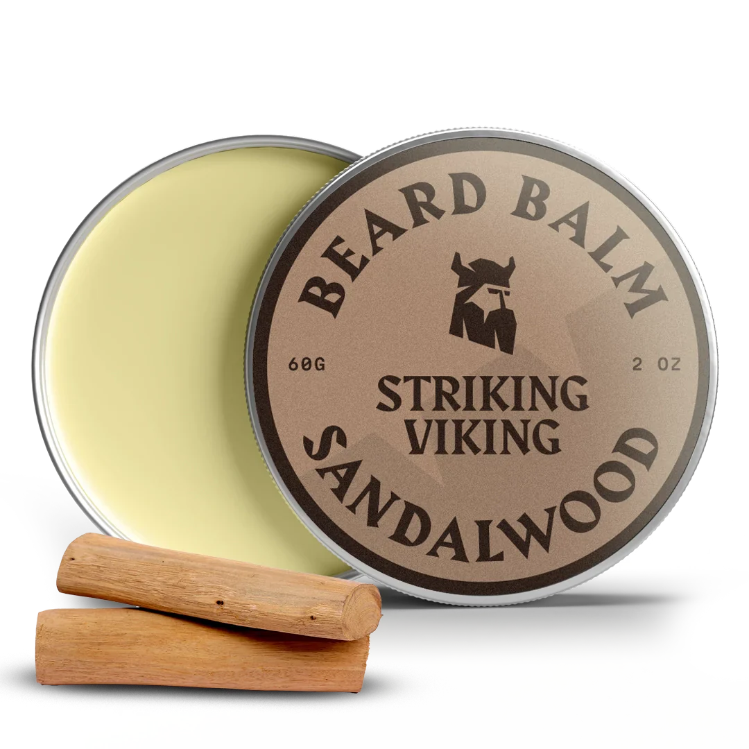 Sandalwood beard balm tin with lid open, two wood pieces beside.