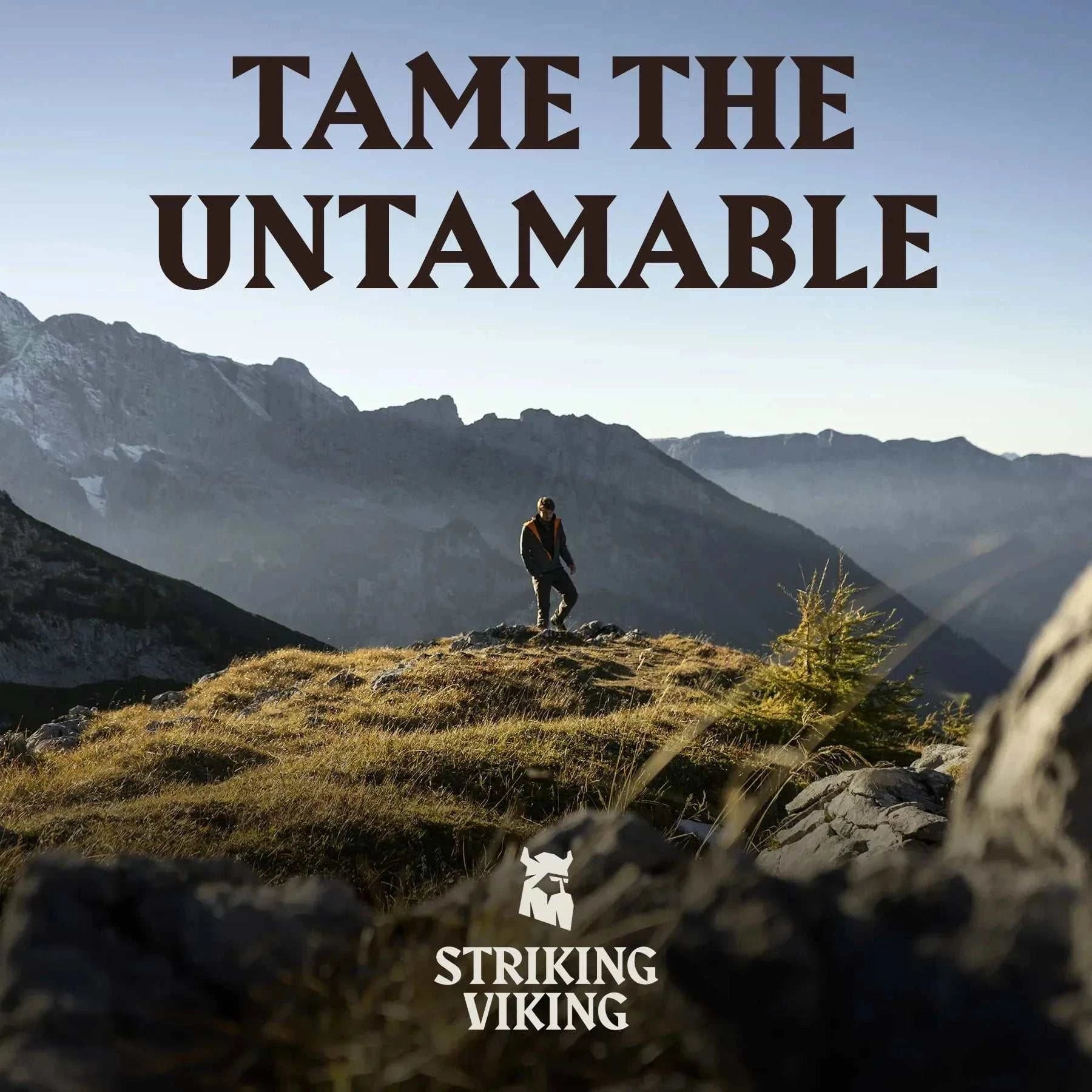Man standing on a mountain with "Tame the Untameable" text, representing Striking Viking's mens shaving cream.