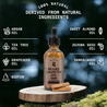 Beard Growth Kit with natural ingredients including argan oil and sandalwood on a wooden stump.
